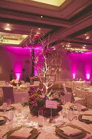 Purple And Red Flowers With Branches For Wedding Centerpiece Magenta Uplighting In Ballroom Wedding Table Flower Centerpieces Wedding Diy Wedding Decorations