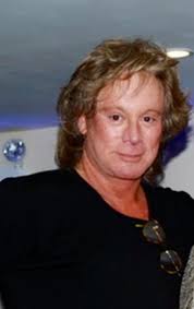 Eric in a suit similar to the one he wore