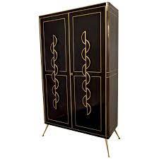 Wipe clean with a moist cloth. 1970s Italian Art Deco Design Gold Brass And Black Glass Tall Cabinet Bar At 1stdibs