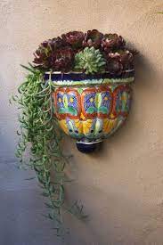 photo of talavera wall container holding plants succulents are a good plant for planters aeoni mexican garden flower pots trailing