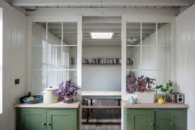 Gingerbread victorian mansion built with red brick including extensive use white trim and supporting columns with a solarium room on the side. Dreamy Colors In A Former Victorian Coach House In Hackney