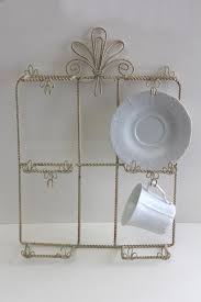 Arrange elegant bone china cups and saucer sets on vintage lace doilies on a sideboard in a formal dining room. Vintage Wrought Wire Wall Mount Display Rack For Cups Saucers French Farmhouse Style Wirework