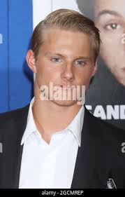 In this July 10, 2013 photo, Daniel Taylor, of Chicago, with back to  camera, who was exonerated after spending nearly two decades in prison for  a double homicide he didn't commit, is