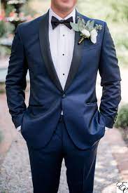 Navy Blue Tux With Coral Boutonniere Designed By Engaging Events Weddingattire Tux Coral N Navy Tuxedo Wedding Navy Blue Suit Wedding Blue Suit Wedding