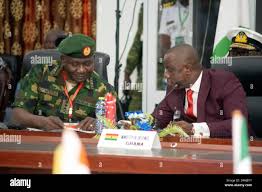 Ghana Defence Minister Dominic Aduna Bingab Nitiwu, right, confers with  Nigerian Chief of Defence Staff General Christopher Gwabin Musa during the  Extraordinary Meeting of the ECOWAS Committee of Chiefs of the Defence