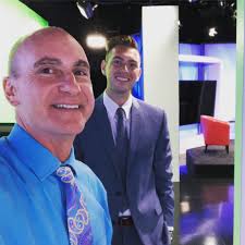 That sharp dressed man behind me is our new sports guy, Blake Sandlin