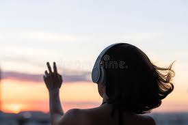 Relaxed Woman with Streaming Hair Wearing Headphones Listening To Music on the Beach at Sunset. Back View, Silhouette Lonely Girl Stock Photo - Image of leisure, music: 193478138