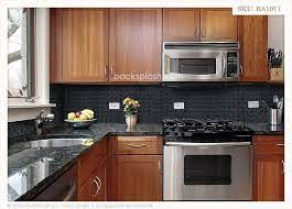 Most people make a contrast with white color backsplash tile, or they use dark color backsplash tile for dramatic effect. Black Granite Glass Tile Mixed Backsplash Black Backsplash Black Granite Countertops Backsplash Black Granite