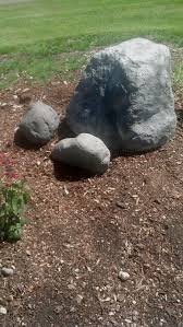 Stones or rocks offer good drainage for a downspout area. Fake Boulder I Created From Cardboard Boxes Newspaper And Chicken Wire Cover In Mortar And Pool Landscaping Around The Pool Landscaping Landscaping Grasses