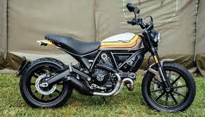 The classic has a black frame, spoked wheels, and a brown leather seat. Ducati Scrambler Mach 2 0