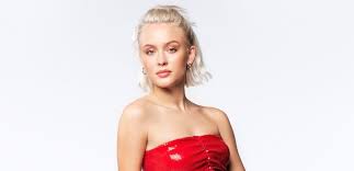 At the age of 10. Zara Larsson Stuns In Low Cut Black Top Skirt With Thigh High Slit