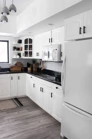 While some are unfinished some cabinets are finished. White Kitchen Cabinets With Black Hardware Decorkeun