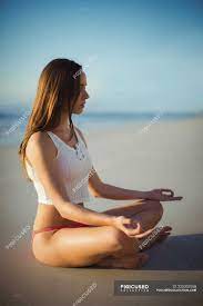 Stock up and save on images and videos with ultrapacks. Beautiful Woman Performing Yoga On Beach On A Sunny Day Relaxation Sea Stock Photo 225302558