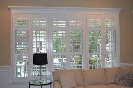 Decorative shutters installed for only aesthetic purposes are not restricted by exact fit requirement. This Large Window In A Downtown Chicago Covered Their Transom With A Separate Shutter For F White Shutters Living Room Bedroom Windows Interior Transom Windows