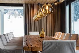 The light in dining rooms should be indirect, like a cascading lighting fixture, pendant lights, or lighting designs with closed lampshades or grayish glass. Modern Luxury Apartment Pendant Lighting In Austrian Alps