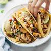 Add cooked fish to a tortilla. 1