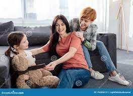 Same Sex Family Sitting Near Daughter Stock Photo - Image of child,  sexually: 176305412