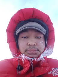 A female Nenet Nomad from the Siberian Tundra uses frozen snow for cooking 