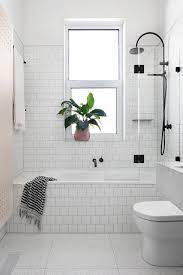 To give the tub a 'softer feeling' i tried thinking outside the box and decided to take off the outer shell and rebuild the base. White Subway Tiles Bathtub With Black Metal Shower Of Shower Bathtub Combo In Bathroom Tub Shower Combo Small Bathroom Remodel Designs Bathroom Remodel Designs