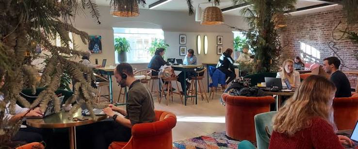 People working from a laptop-friendly cafe