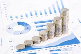 Closeup Stacks Of Thai Baht Coins On Blue Graphs And Charts