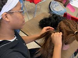 Braiding club at JCPS middle school teaching girls entrepreneur skills