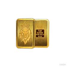 Close-up of a 4-gram 22 K gold piece stamped with its weight and Daman hallmark on a dark background.