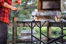 Portable folding outdoor cook station with counter and storage space for a camping stove or grill, cooking utensils, and cookware. Gci Outdoor Tables Camp Kitchens Tailgater Magazine