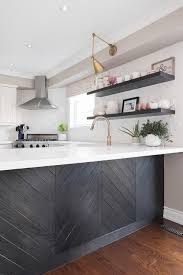 Black And White Quartz Kitchen Black Wood Herringbone Trim Accents A Kitchen Peninsula Fitted With A White Quartz Countertop Kitchen Peninsula Replacing Kitchen Countertops Dark Countertops