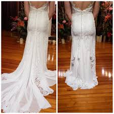 Take hold of the middle of the train of the dress and lift it until it is even with the hemline. Bustles The Gilded Thimble