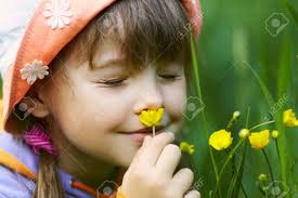 Screwed-up Girl Closeup Smelling A Yellow Flower On A Green Background  Stock Photo, Picture and Royalty Free Image. Image 13544281.