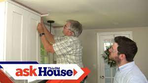 Use a pin nailer to nail into the corners of the two pieces of crown molding (image 2). How To Hang Crown Molding On Kitchen Cabinets Ask This Old House Youtube