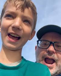 Charles McKenzie and son, Charlie, demonstrate chimpanzee call he learned  from Jane Goodall