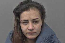 A heroin-addicted woman claimed that she was "in the wrong place at the  wrong time" when police searched a house and saw her sitting at a kitchen  table surrounded by drugs. Katie