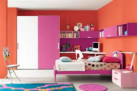 Here, a fun rattan bed frame and colorful tropical bed linens paired against the deep, navy wall give this space a trendy rise and shine with a sunny combination of soft yellow and periwinkle blue. M S Room Orange Pink Color Combination Bedroom Design Modern Kids Bedroom Childrens Bedroom Furniture