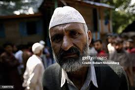 Portrait of Ghulam Mohammad Lone as he poses with a photo of his dead...  News Photo