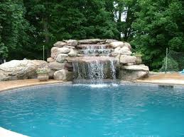 Swimming pool waterfall kits are the most foolproof waterfalls on the market. 7 Features That Make Your Pool Design More Exciting Pool Waterfall Backyard Pool Landscaping Swimming Pool Waterfall