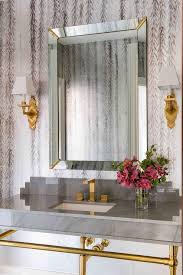 Carrara marble tiles are a classic white marble with a mixed fleuri and vein cut that blend to create subtle yet distinctive patterns. Gold And Gray Bathroom With Carrera Marble Transitional Bathroom