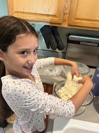 Homeschool family cooks together in the kitchen