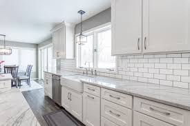 The traditional kitchen has a feeling of the house by using raised panel doors in warm finished brown cabinets with black galaxy countertops. How To Pick The Right Backsplash For Your Countertop Swita Cabinetry