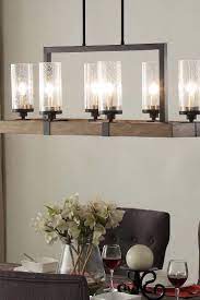 A linear dining room lighting fixture works with the artful screen and other elements. Top 5 Light Fixtures For A Harmonious Dining Room Overstock Com Dining Light Fixtures Dinning Room Lighting Dining Room Lighting