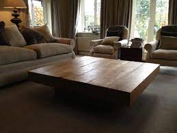 Coffee tables were replaced with two oversized tufted ottomans in dark gray which sit on a custom made beige and cream zebra pattern rug. Large Oak Coffee Table