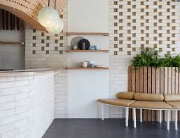 The aero leather ottomans and the blue sabine chairs are from room & board. Dessert Store Uses Brick And Wood For A Minimalist Interior Design