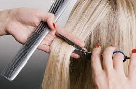 Creative hair designs is a family oriented full service salon that has been serving the greater green bay area since 1989. Hairdresser Cutting Blonde Hair Closeup Over Grey Background Kelly S Creative Hair Designs