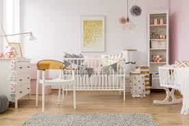 A boho nursery with a folksy print wallpaper wlal, a leather ottoman, a tassel basket and a neutral boho rug. 45 Baby Girl Nursery Room Ideas Photos Home Stratosphere