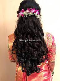 The indian braids are among the most versatile and lovely hairstyles in the whole world. Reception Hairstyle By Swank Big Curls Hairstyle With Fresh Orchids Bridal Hair Bridal Silk Saree Saree Hair Styles Indian Bride Hairstyle Saree Hairstyles