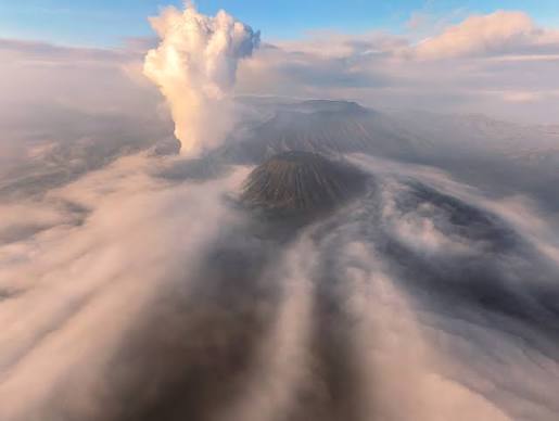A view of the smoke plumes rising from the volcanic landscape of Mount Bromo in East Java, Indonesia.