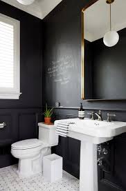 The black framed metal mirror, the dark navy paint and the squared edges of the pedestal sink lend a masculine vibe. Powder Room Accent Wall Design Ideas
