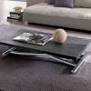 The round coffee table shows off a versatile look with a rich gray wood finish. 1