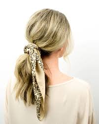 A ponytail that is tied lower on the person's head, typically near the nape of the neck. Low Ponytail With Scarf Tutorial Lulus Com Fashion Blog